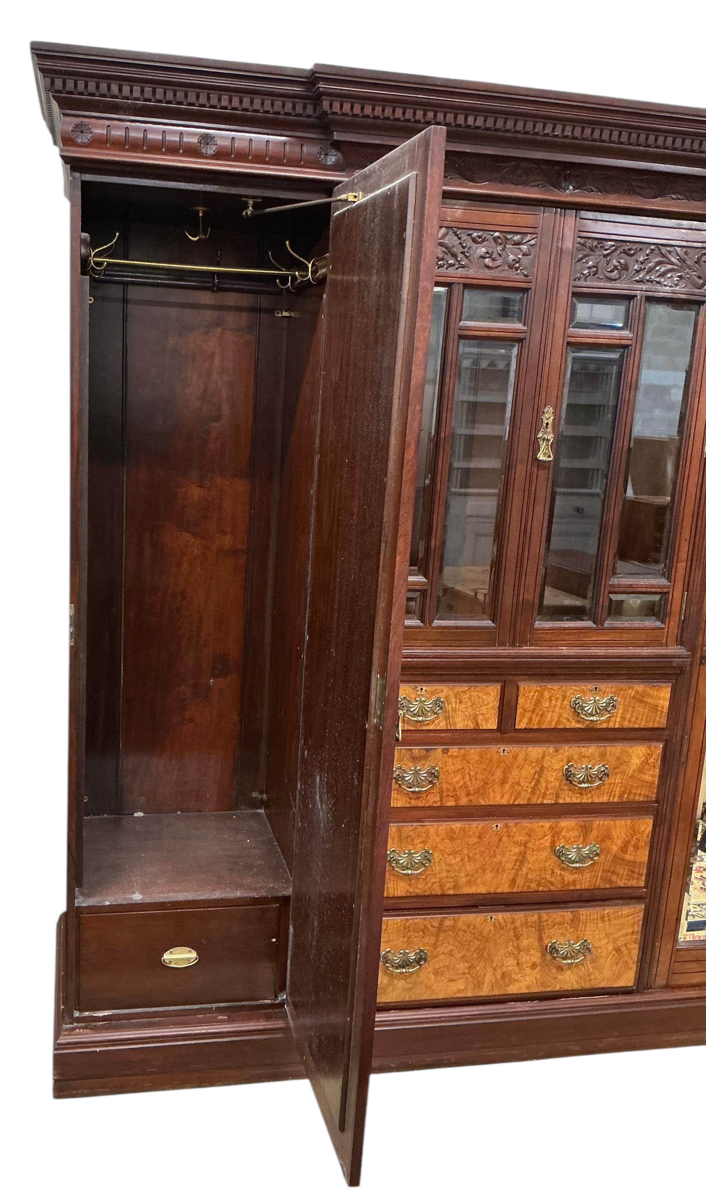 A late Victorian carved mahogany mirrored wardrobe, width 208cm, depth 60cm, height 218cm